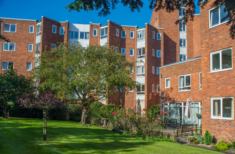 Block of flats and gardens on a sunny day