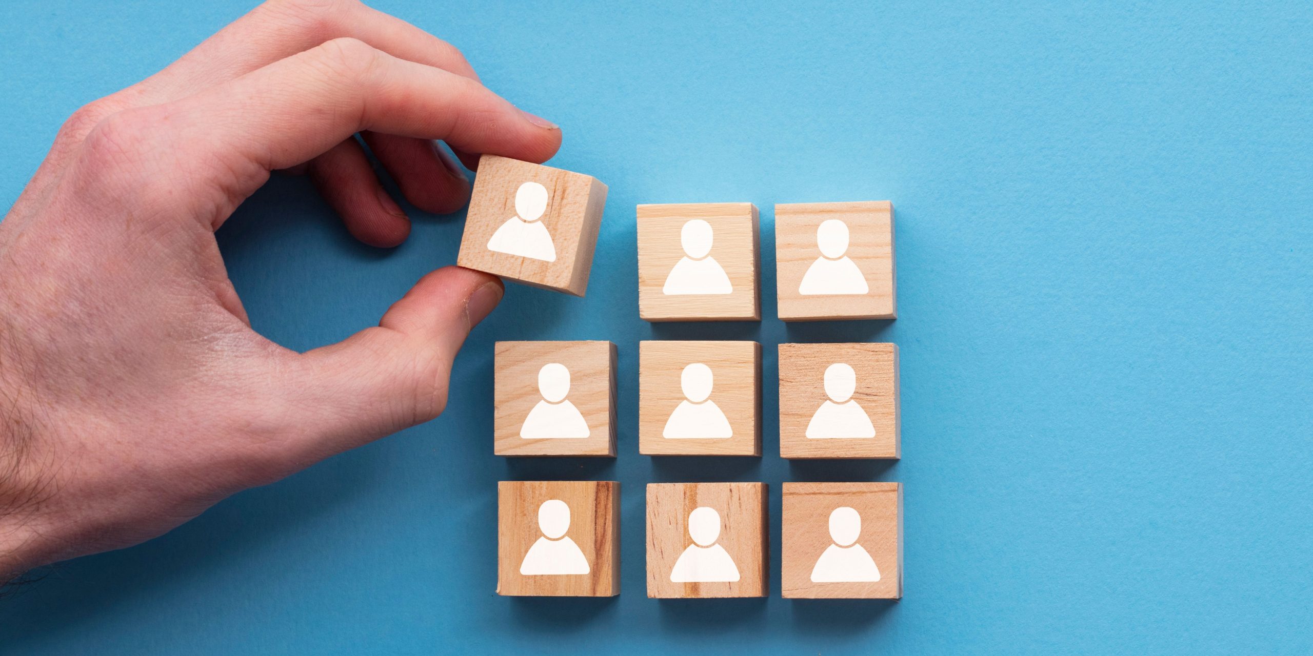 Wooden building blocks showing team members.